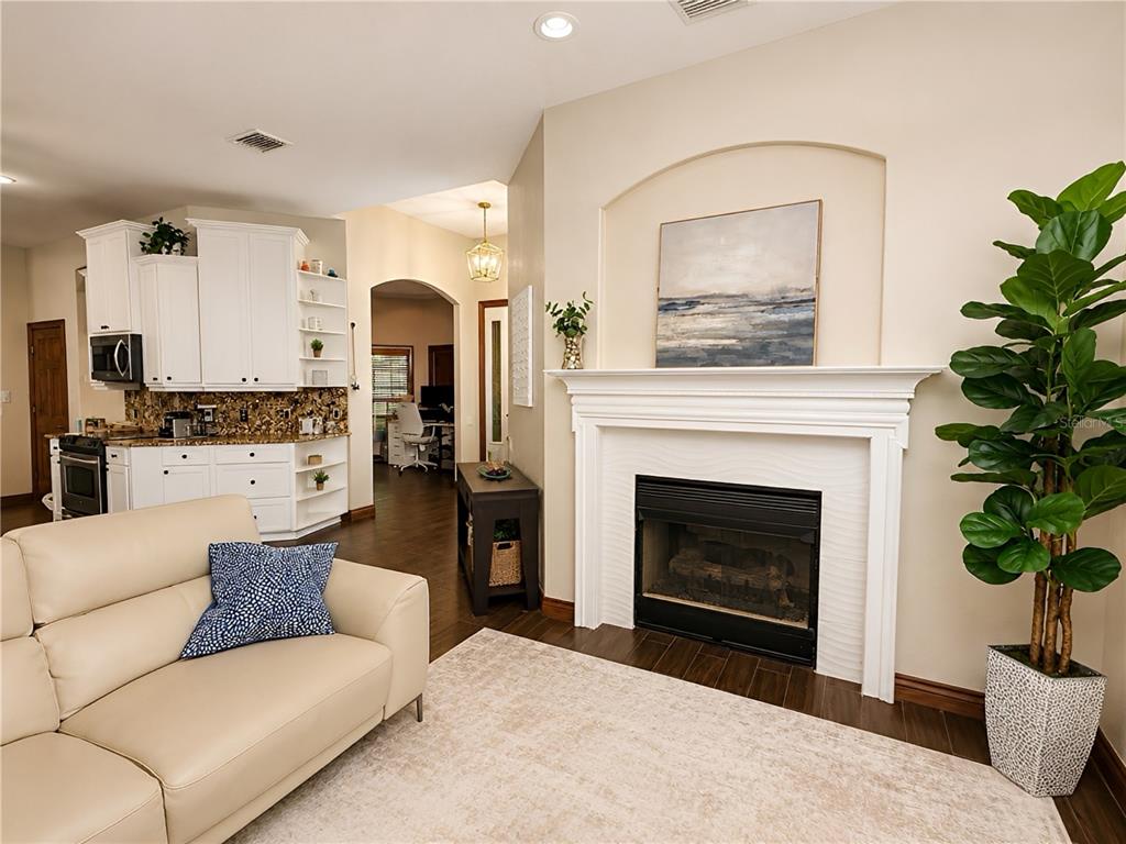 A backyard features a stone-rimmed hot tub, a swimming pool, and a lake view — 17802 SAINT LUCIA ISLE DRIVE, TAMPA, FL