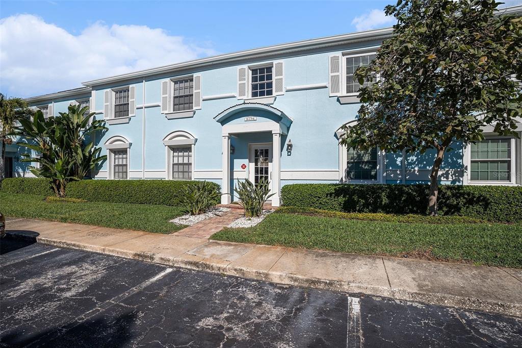 A two-story light blue building with white trim and a central covered entryway — 5176 SALMON DRIVE SE UNIT D, ST PETERSBURG, FL