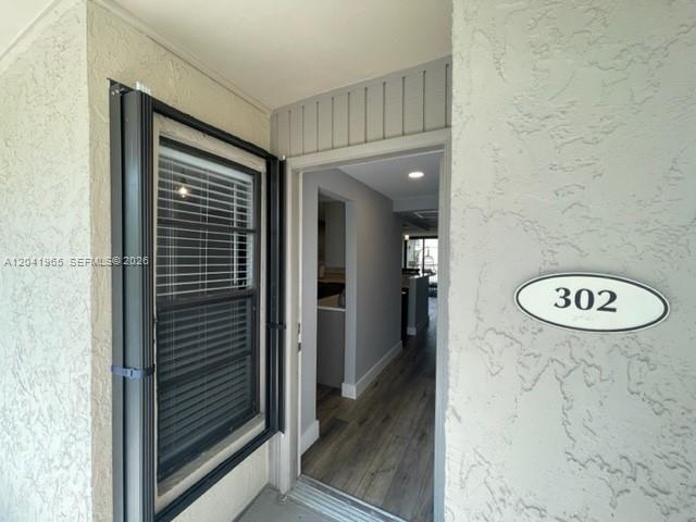 An exterior view shows a doorway labeled 302 with a window and wood-look flooring inside — 17 Royal Palm Way # 302, Boca Raton FL 33432, BOCA RATON, FL