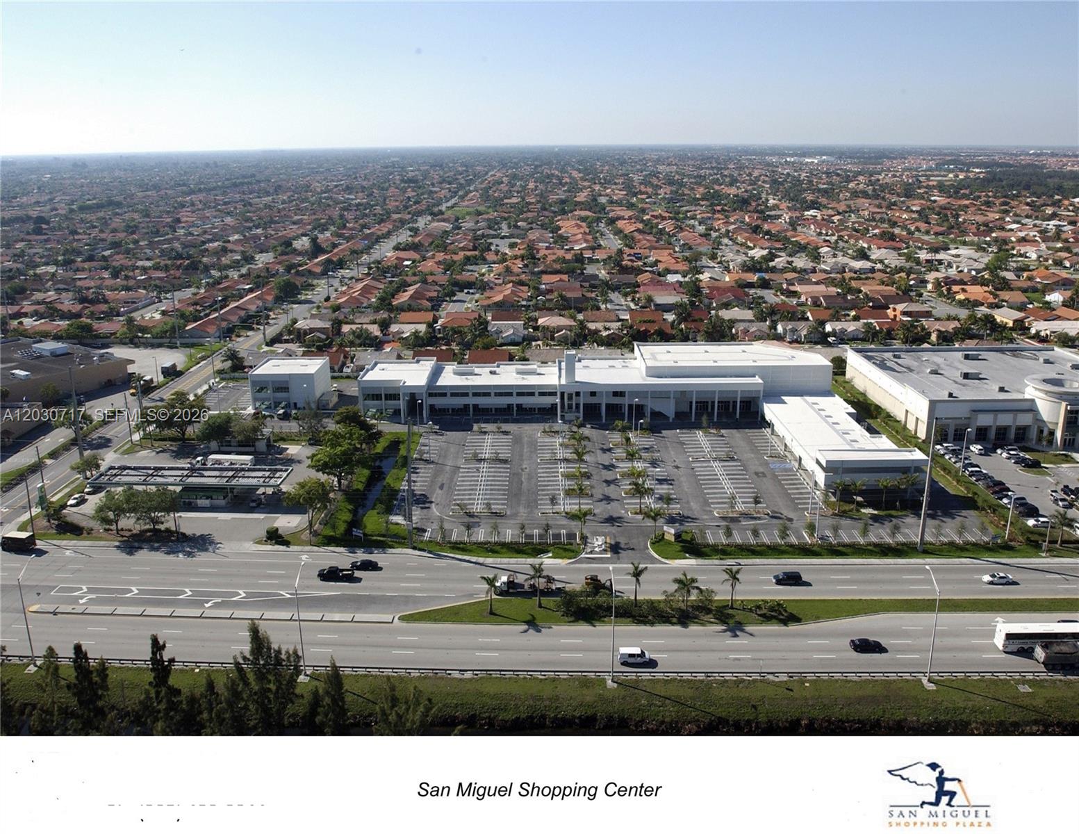 An aerial view of the San Miguel Shopping Center with a large parking lot — 13944 SW 8th St # 201, Miami FL 33184, MIAMI, FL