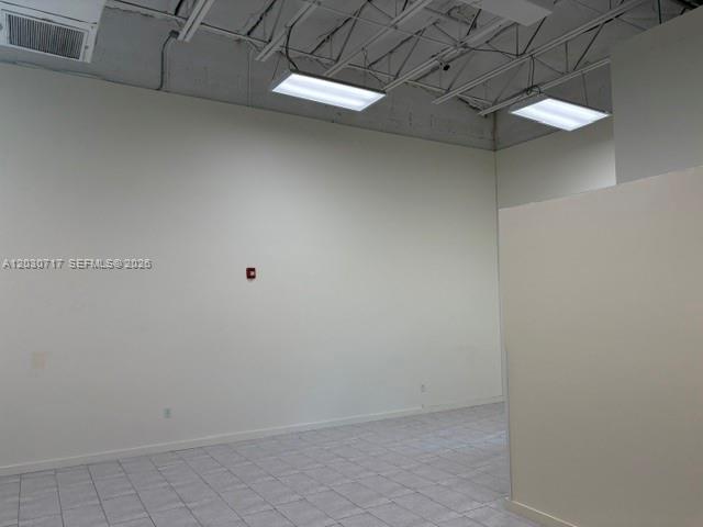 An empty commercial space features white walls, tiled flooring, and exposed ceiling lighting — 13944 SW 8th St # 201, Miami FL 33184, MIAMI, FL