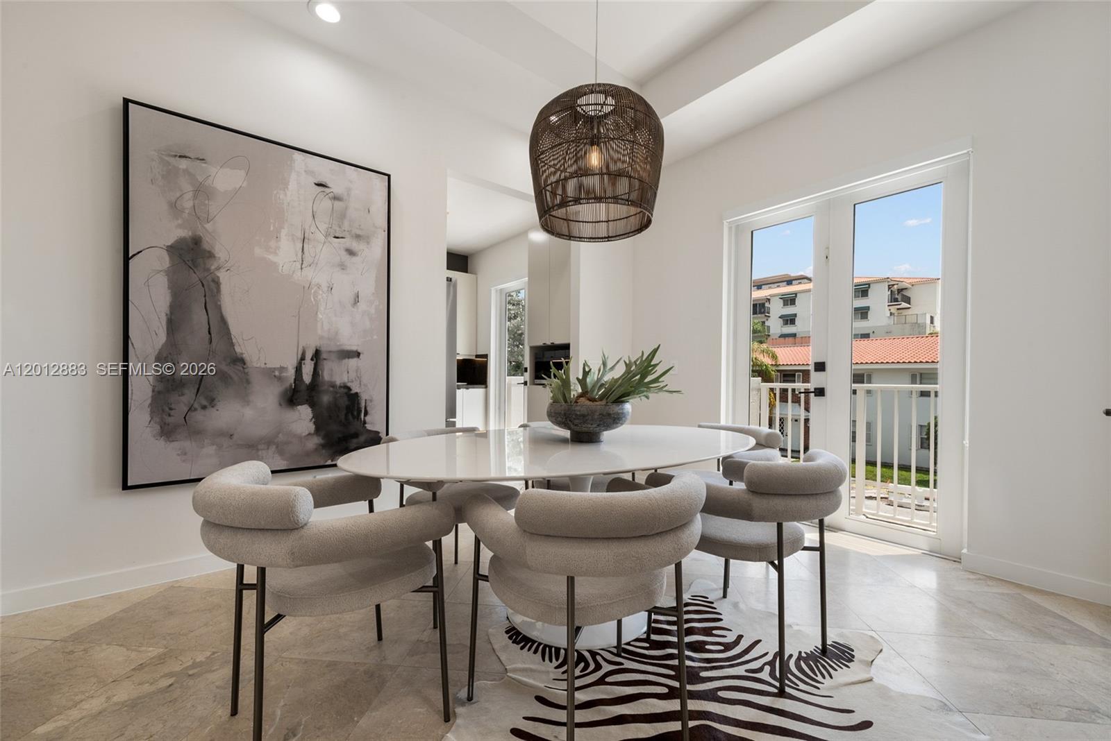 A dining room features a white oval table, gray chairs, a zebra rug, and balcony doors — 349 Madeira Ave # 349, Coral Gables FL 33134, CORAL GABLES, FL