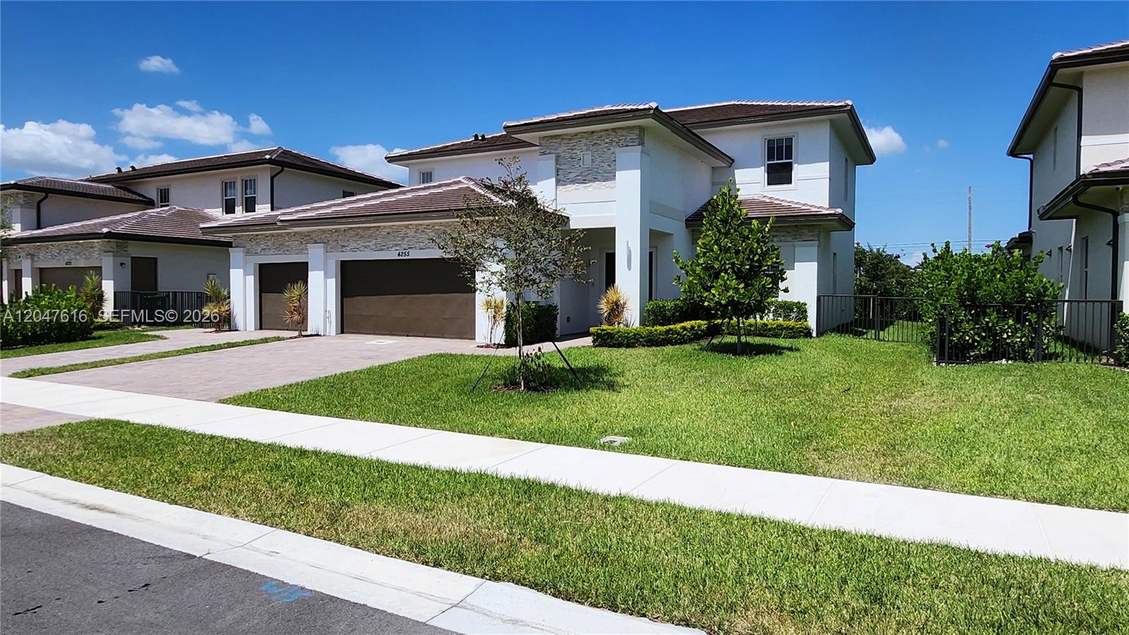 A two-story suburban house with a brown garage door and a manicured front lawn — 4255 SW 123rd Ter, Davie FL 33330, DAVIE, FL