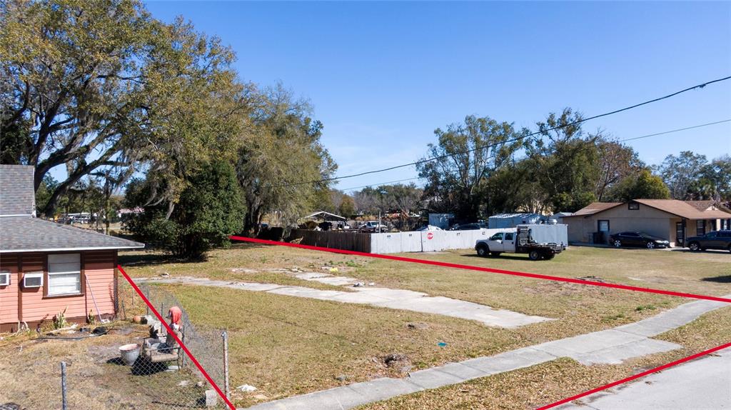 An empty residential lot with a concrete driveway is outlined in red — 155 MA BOARD STREET, APOPKA, FL