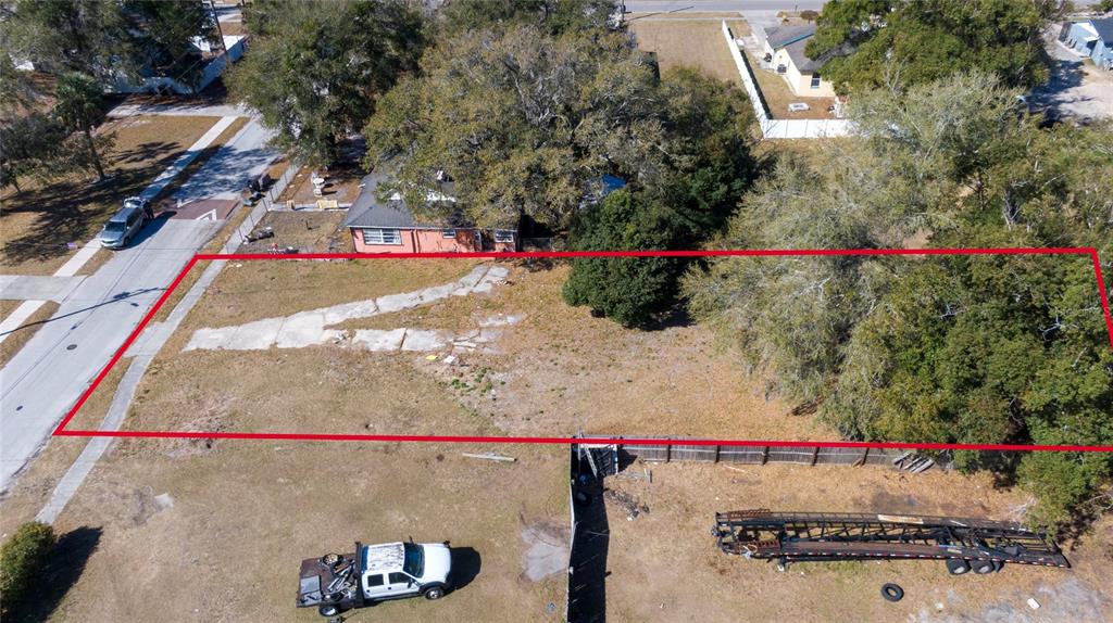 An aerial view shows a vacant rectangular lot outlined in red next to a house — 155 MA BOARD STREET, APOPKA, FL