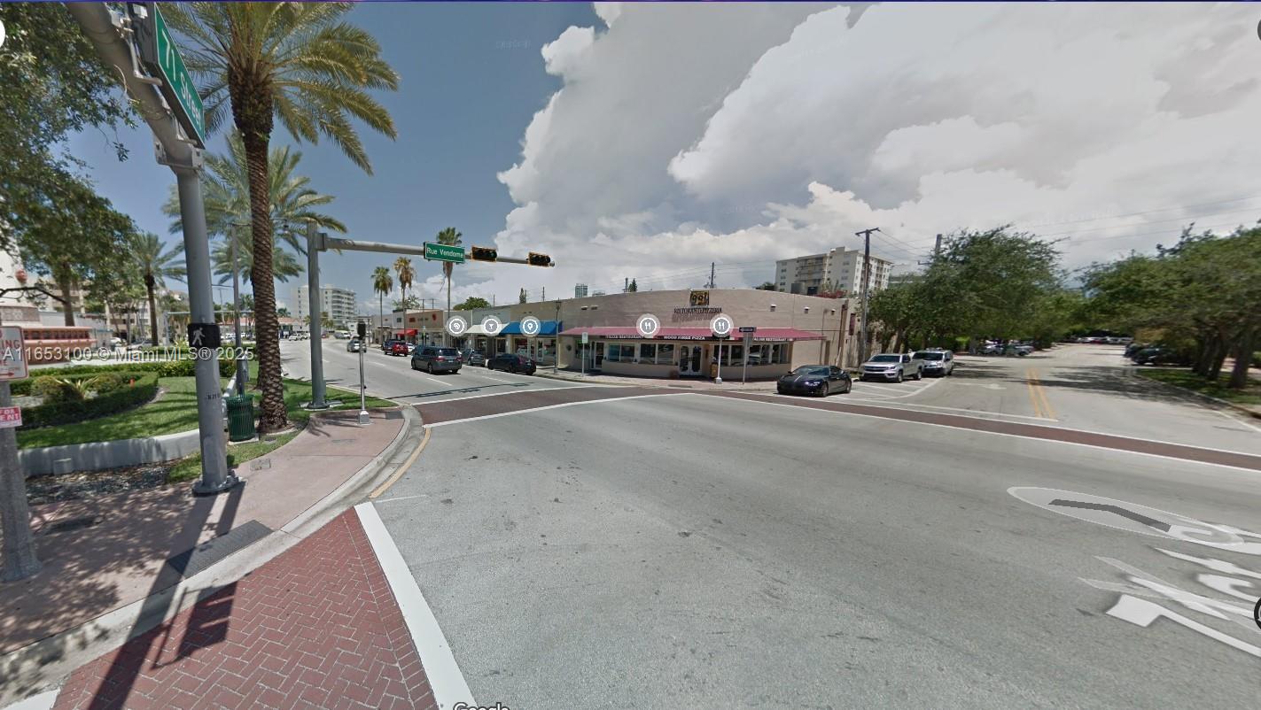 An exterior street view of a corner commercial building with a restaurant and palm trees — 940 71st St, Miami Beach FL 33141, MIAMI BEACH, FL