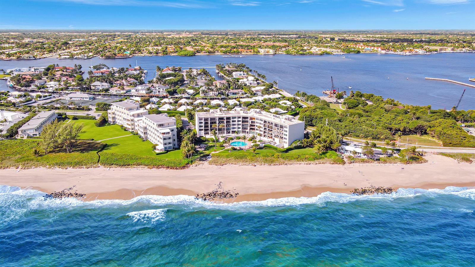 An aerial view shows two beachfront apartment buildings with a pool and surrounding coastal landscape — 6885 N Ocean Boulevard # 3040, Ocean Ridge FL 33435, OCEAN RIDGE, FL