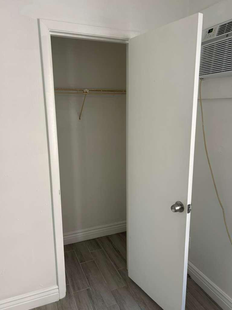 A white interior door opens to a small closet with a single wire shelf — 1081 SE Monterey Road # 12, Stuart FL 34994, STUART, FL