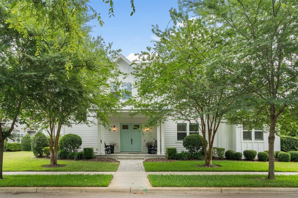 A two-story white house with a light blue front door and a covered porch — 741 SW 133RD WAY, NEWBERRY, FL