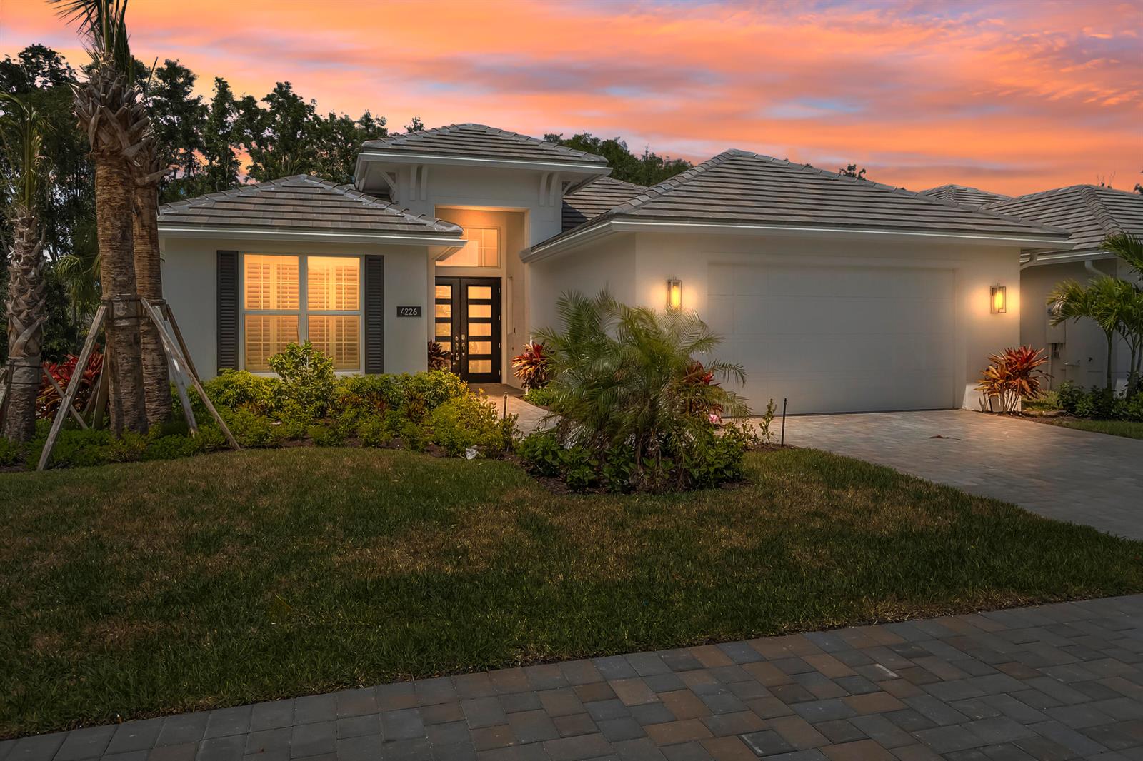 A single-story house with a tiled roof, a paved driveway, and a landscaped front yard — 4226 Lucaya Pointe Way, Vero Beach FL 32967, VERO BEACH, FL
