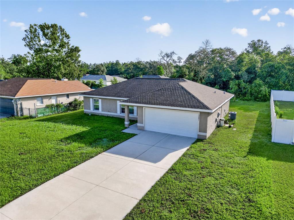 An aerial view shows several suburban houses with driveways, lawns, and surrounding trees — 13881 SW 33RD TERRACE, OCALA, FL
