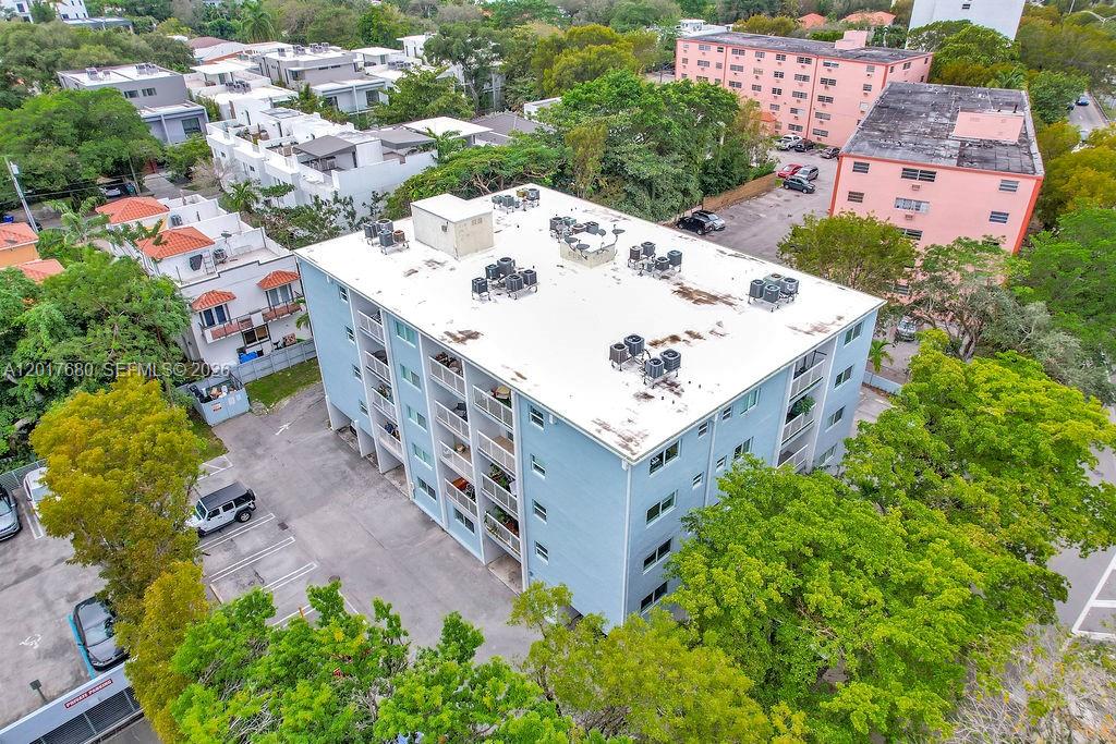 An aerial view shows a light blue multi-story apartment building with a flat roof — 2920 SW 28th Ter # 207, Miami FL 33133, MIAMI, FL