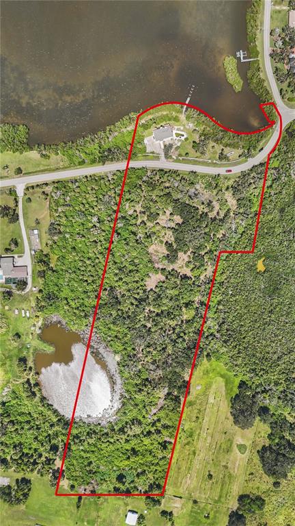 An aerial view shows a large, wooded waterfront lot outlined in red — 1460 BAYSHORE DRIVE, TERRA CEIA, FL