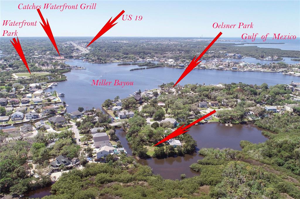 This aerial view shows Miller Bayou, surrounding residential properties, and nearby landmarks like US 19 — 5274 MILLER BAYOU DRIVE, PORT RICHEY, FL