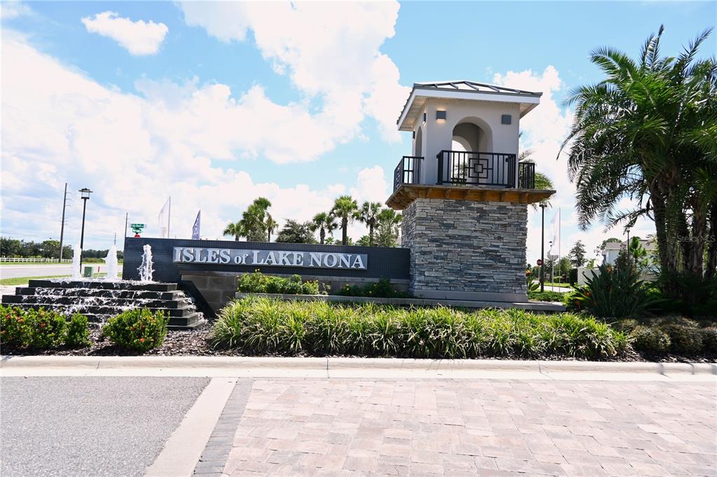 A stone monument sign for Isles of Lake Nona features a fountain and tower — 14440 ORCHID ISLAND DRIVE, ORLANDO, FL