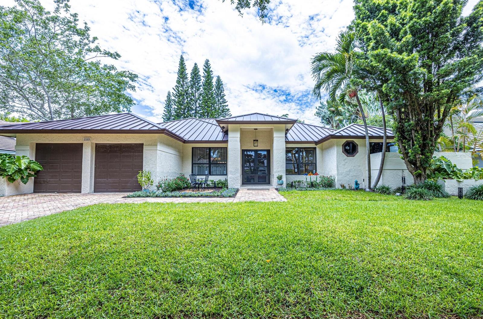 A single-story house with a brown metal roof, stucco exterior, and a two-car garage — 1985 Parkside Circle S, Boca Raton FL 33486, BOCA RATON, FL