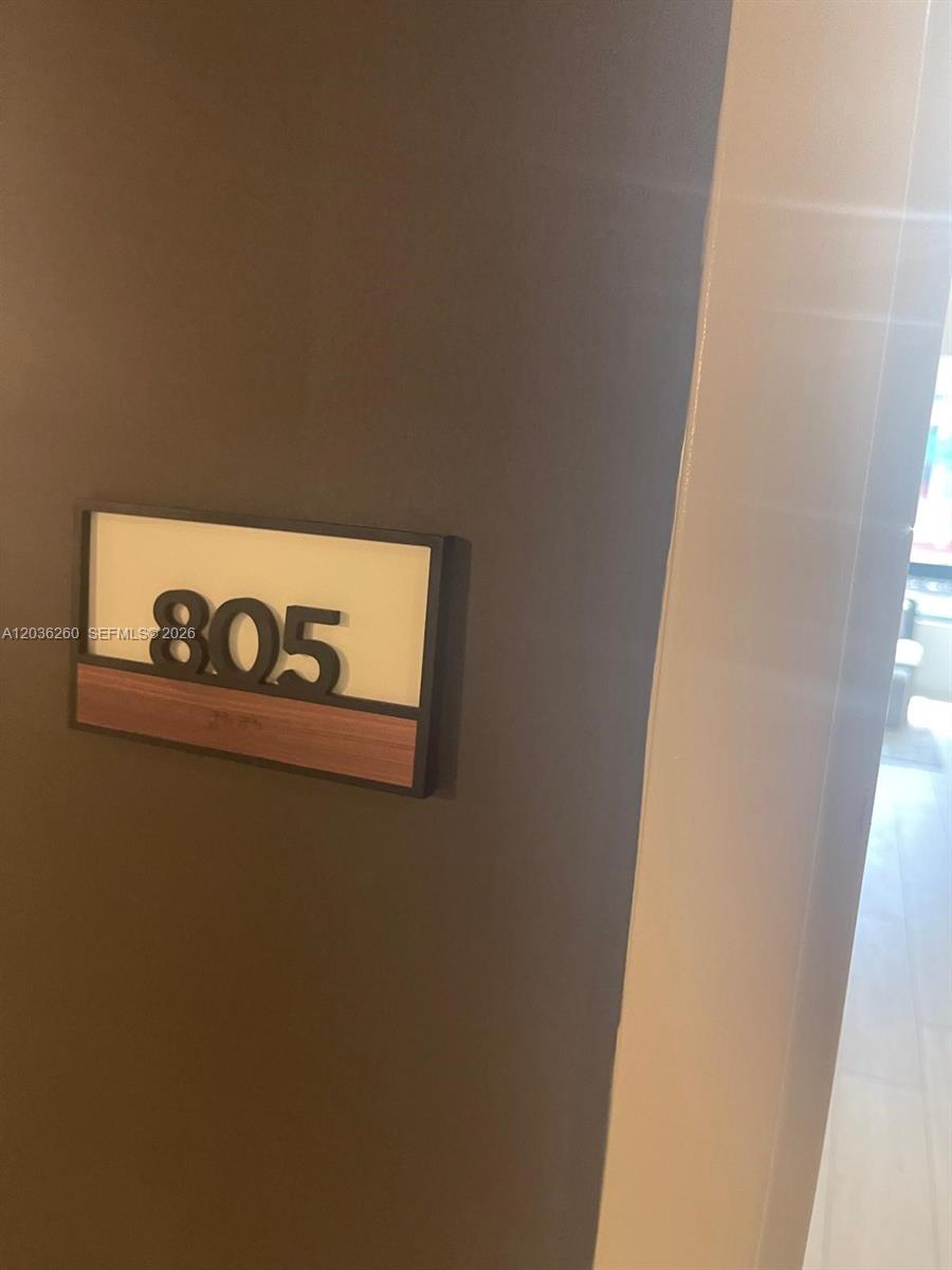 A wall-mounted sign displays the number 805 next to a doorway — 225 N Miami Ave # 805, Miami FL 33128, MIAMI, FL