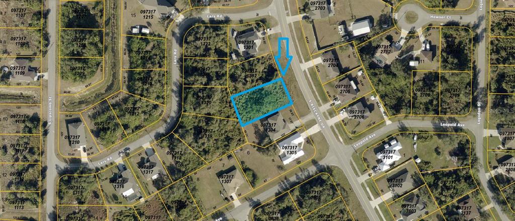 This is an aerial map view showing a vacant, wooded lot highlighted in blue — S BISCAYNE DRIVE, NORTH PORT, FL