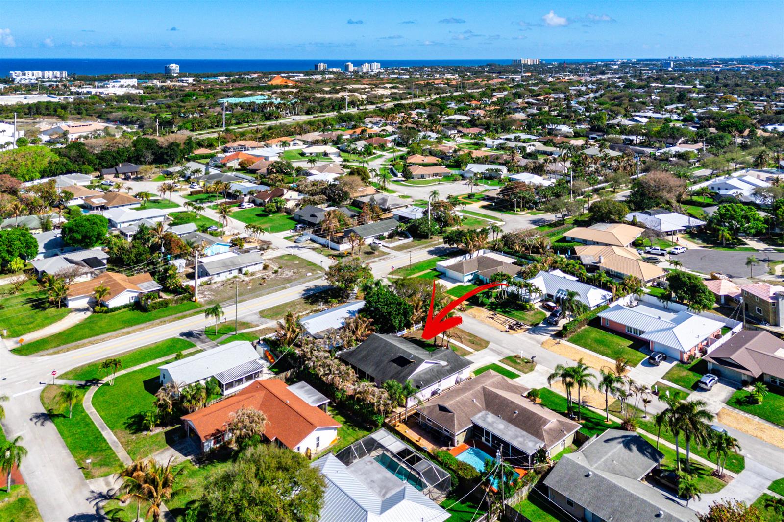 An aerial view shows a residential neighborhood with a red arrow pointing to a house — 4153 Russell Street, Jupiter FL 33469, JUPITER, FL