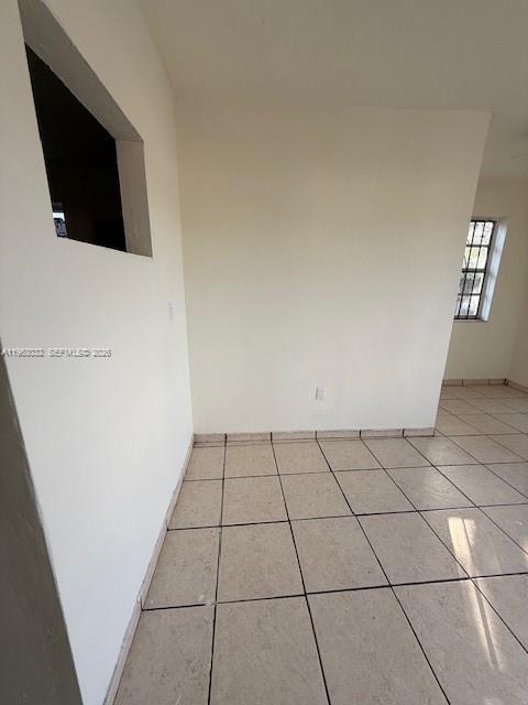 An empty room with beige tile flooring, white walls, and a window with security bars — 14620 Monroe St # x, Miami FL 33176, MIAMI, FL