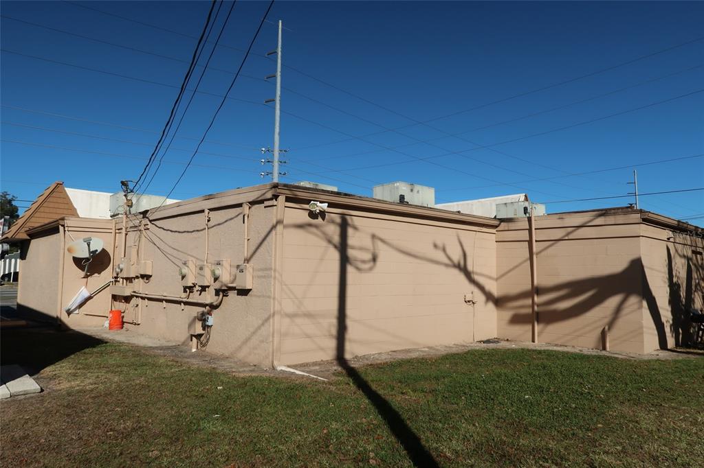The exterior of a tan, flat-roofed commercial building features several electrical meters and utility conduits — 1170 W STATE ROAD 436, ALTAMONTE SPRINGS, FL