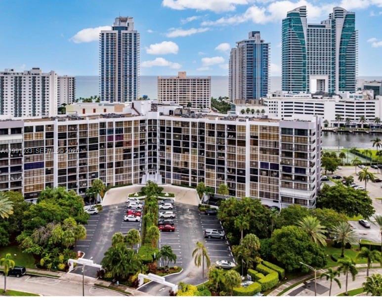 A spacious lobby features marble tile flooring, a large central pillar, and multiple seating areas — 600 Parkview Dr # 717, Hallandale Beach FL 33009, HALLANDALE BEACH, FL