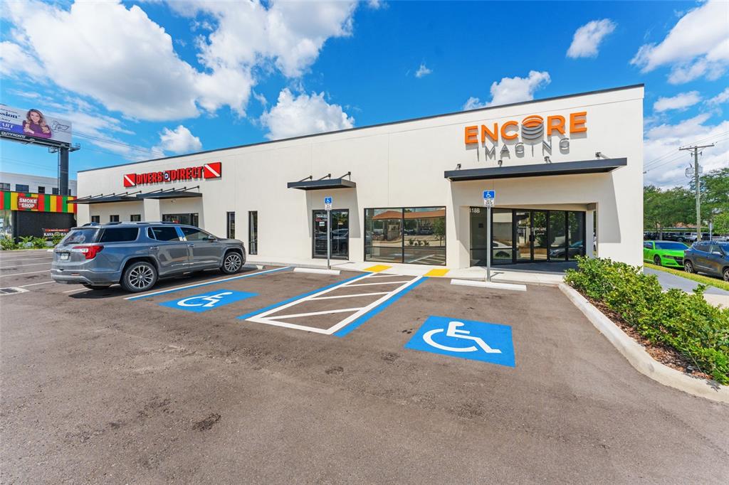 The exterior of a commercial building features two storefronts with handicap parking spaces in front — 418 N DALE MABRY HIGHWAY, TAMPA, FL
