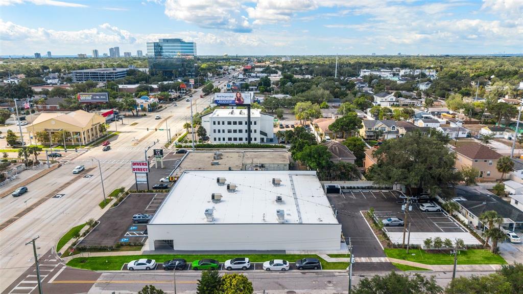 An aerial view shows a commercial building with a flat roof and an adjacent parking lot — 418 N DALE MABRY HIGHWAY, TAMPA, FL