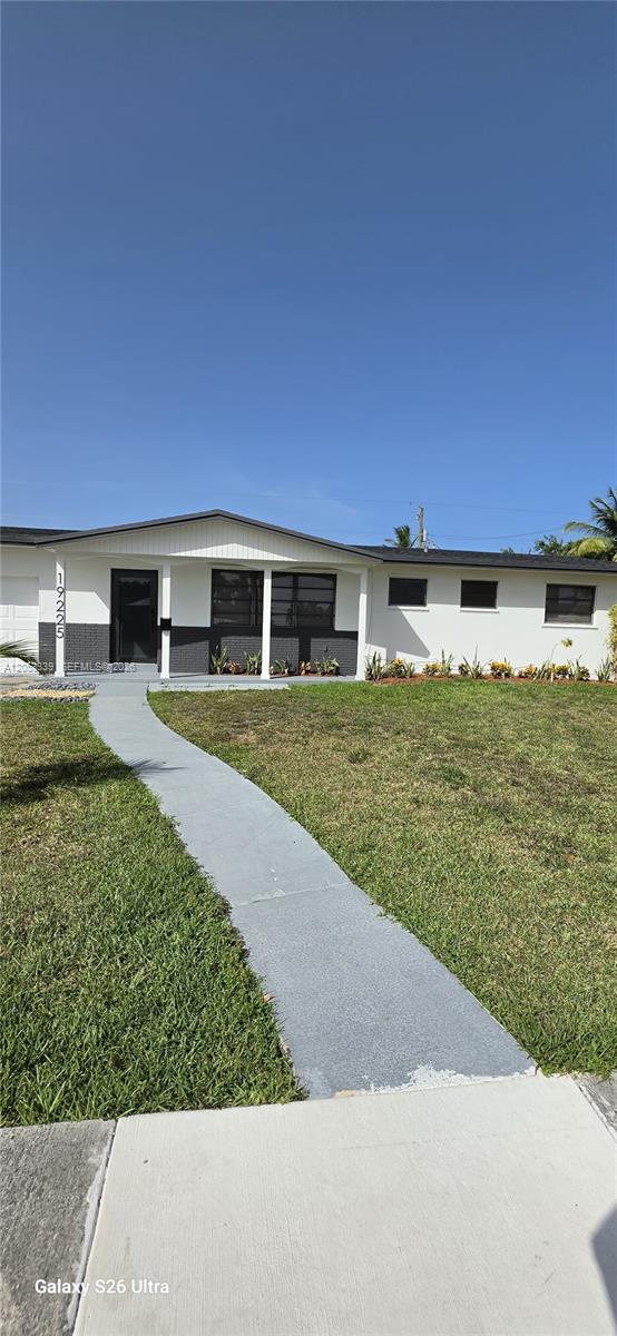 A single-story house with a white exterior, dark brick accents, and a concrete walkway — 19225 Franjo Rd, Cutler Bay FL 33157, CUTLER BAY, FL