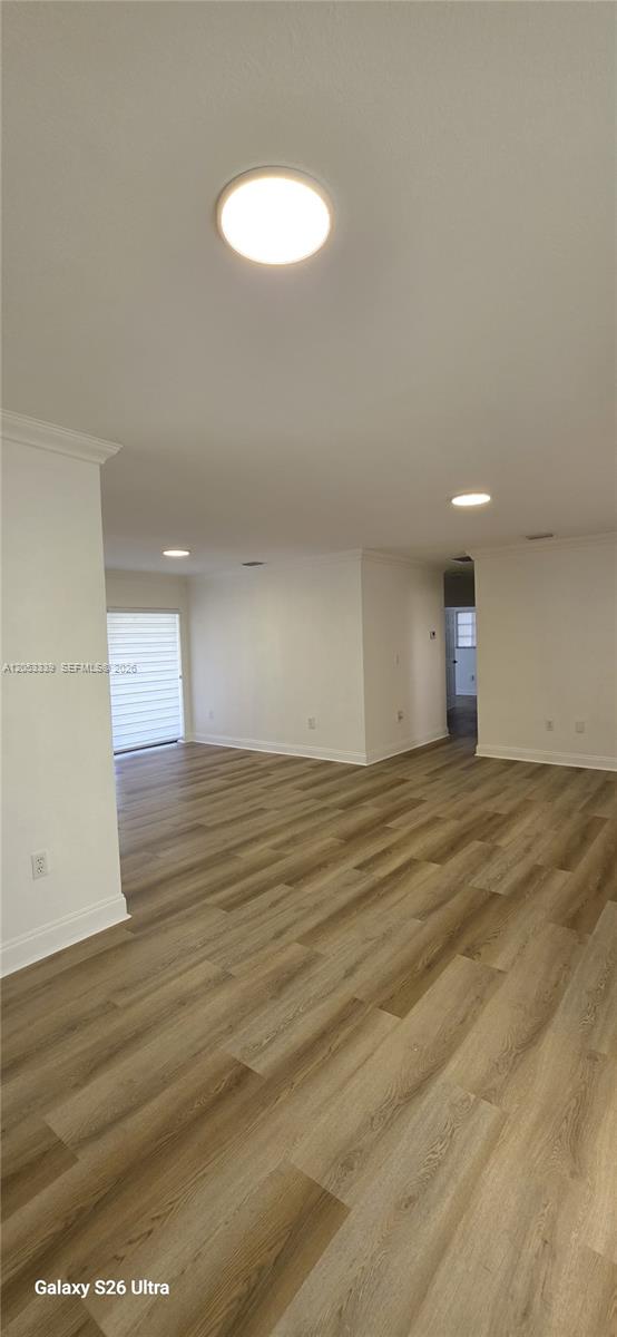An open-concept living area features light wood-look flooring, white walls, and recessed ceiling lighting — 19225 Franjo Rd, Cutler Bay FL 33157, CUTLER BAY, FL