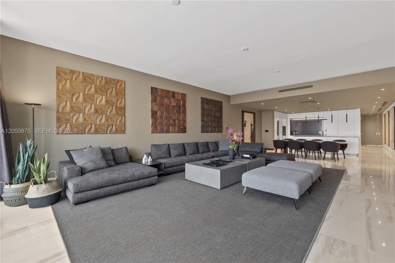 A spacious living room features a large gray sectional, modern coffee tables, and wall art — 300 Biscayne Blvd Way # 3104, Miami FL 33131, MIAMI, FL