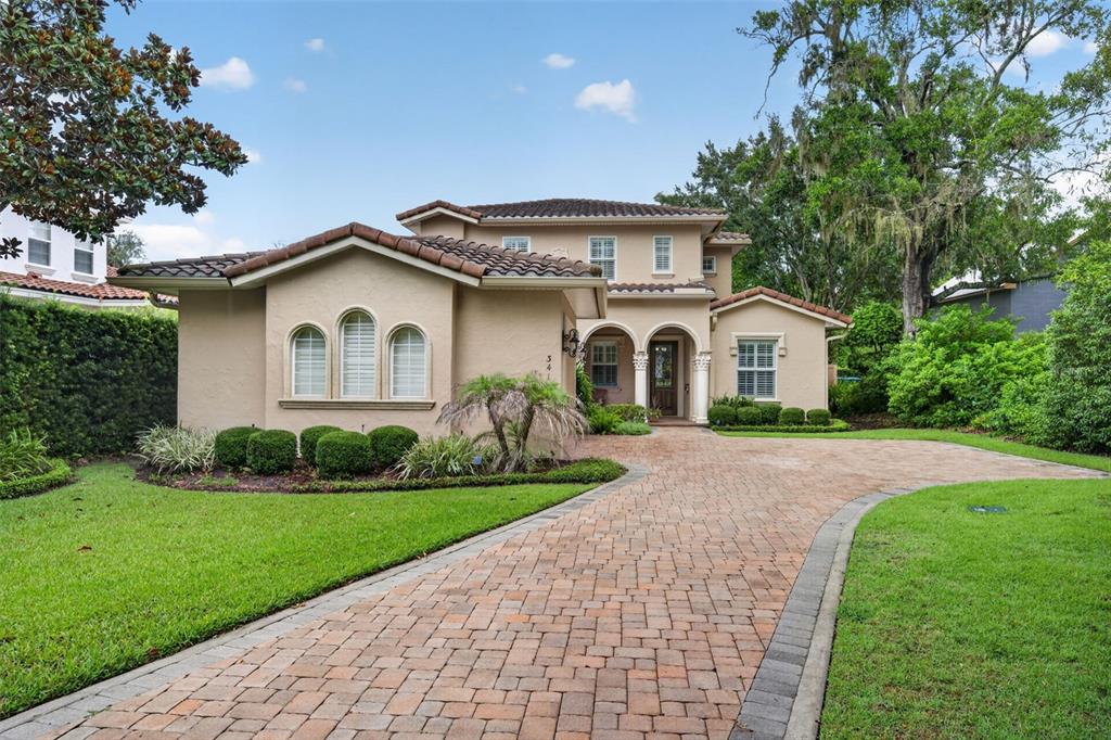A two-story stucco house with a tile roof and a brick paver driveway — 341 E READING WAY, WINTER PARK, FL