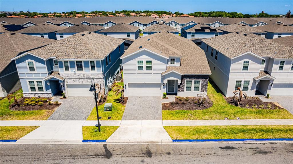 An aerial view shows two suburban houses with paved driveways and manicured lawns — 4453 KAIPO ROAD, DAVENPORT, FL