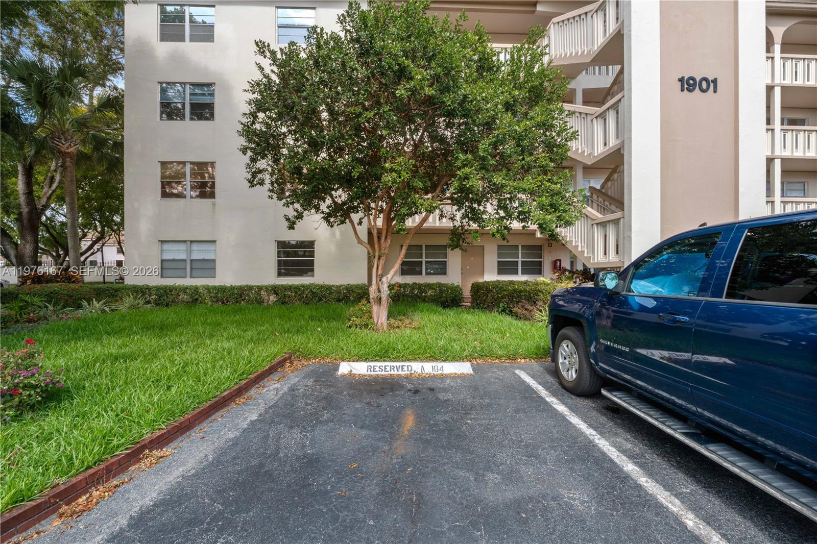 A blue pickup truck is parked in a reserved space in front of an apartment building — 1901 Bermuda Cir # A1, Coconut Creek FL 33066, COCONUT CREEK, FL