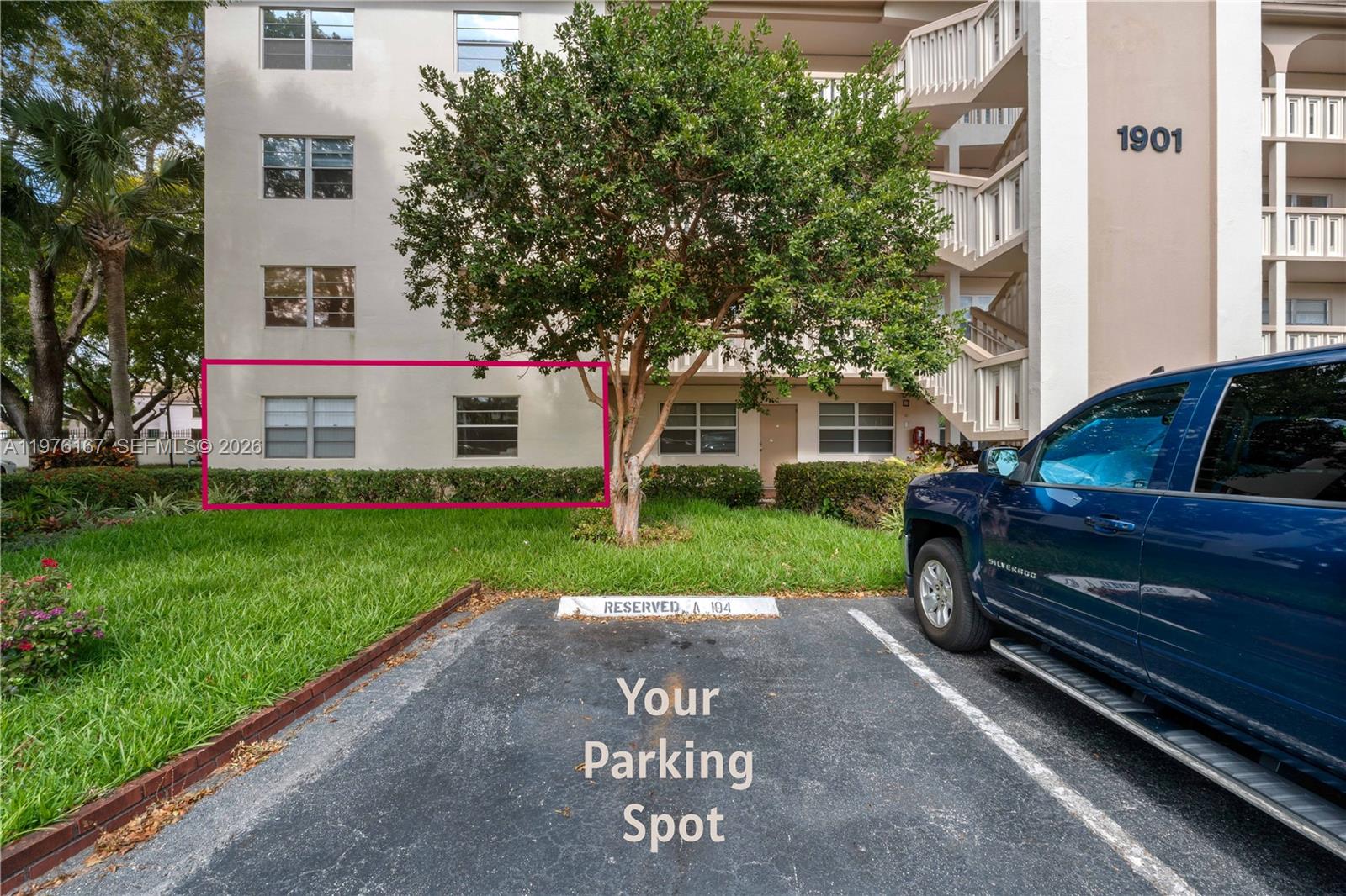 A ground-floor apartment exterior features two windows highlighted by a pink rectangle near parking — 1901 Bermuda Cir # A1, Coconut Creek FL 33066, COCONUT CREEK, FL