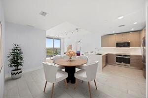 A modern open-concept kitchen and dining area with light wood cabinets and tile flooring — 2000 Metropica Way # 802, Sunrise FL 33323, SUNRISE, FL