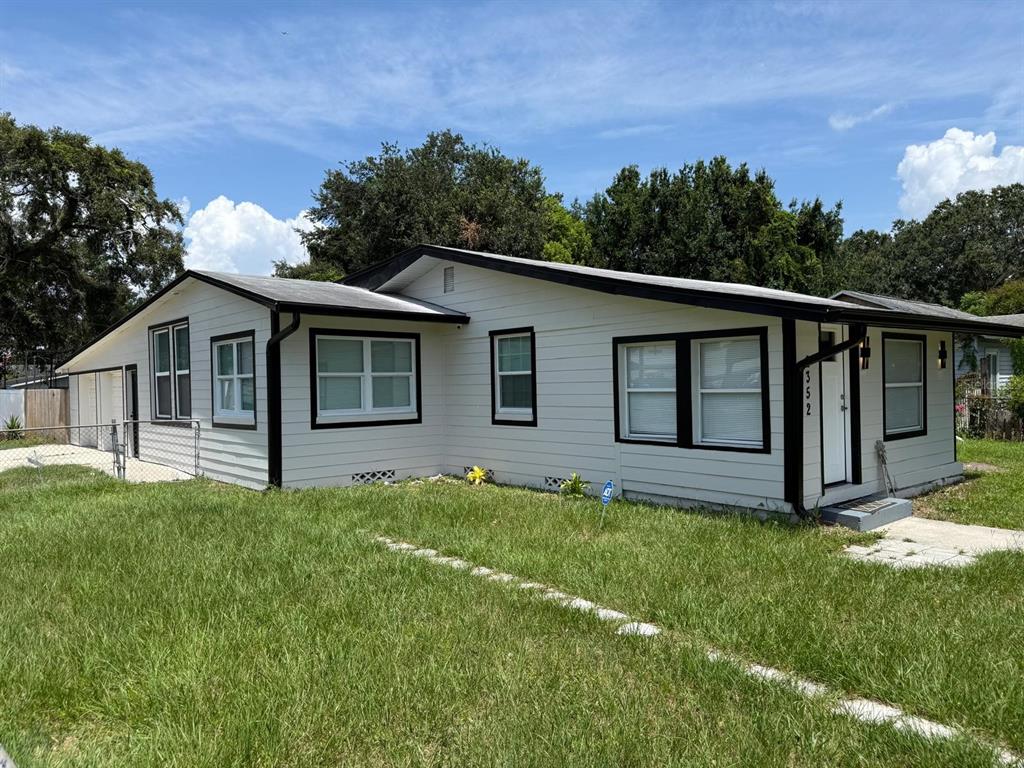 A single-story house with light gray siding, black trim, and a white front door — 2352 OLD DIXIE HIGHWAY, KISSIMMEE, FL
