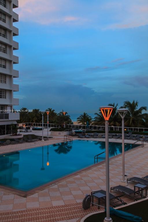 A swimming pool with lounge chairs sits on a patio next to a tall building — 100 Lincoln Rd # 943, Miami Beach FL 33139, MIAMI BEACH, FL