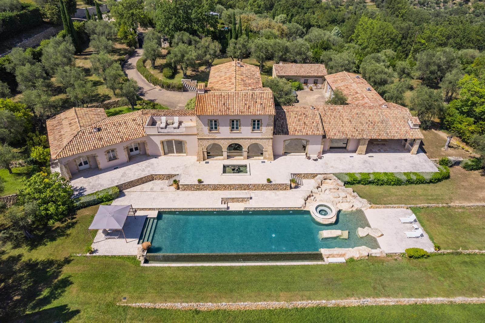 An aerial view of a large stone villa with a pool, patio, and surrounding trees — 20 Chemin De Bellevue, FL