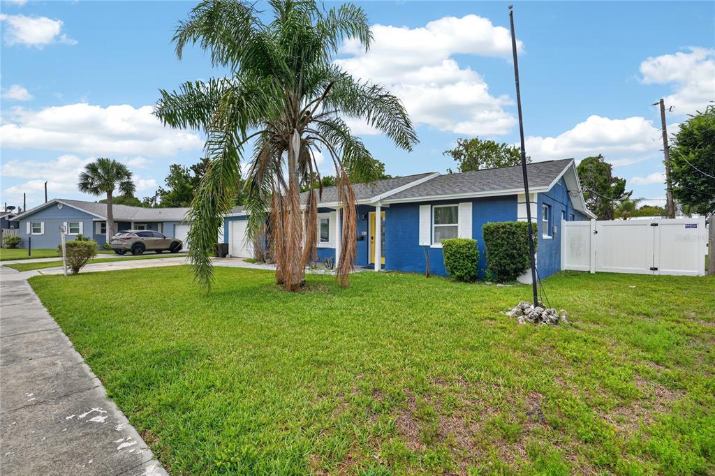 A blue single-story house with a palm tree in the front yard — 2354 GREEN STREET, SOUTH DAYTONA, FL
