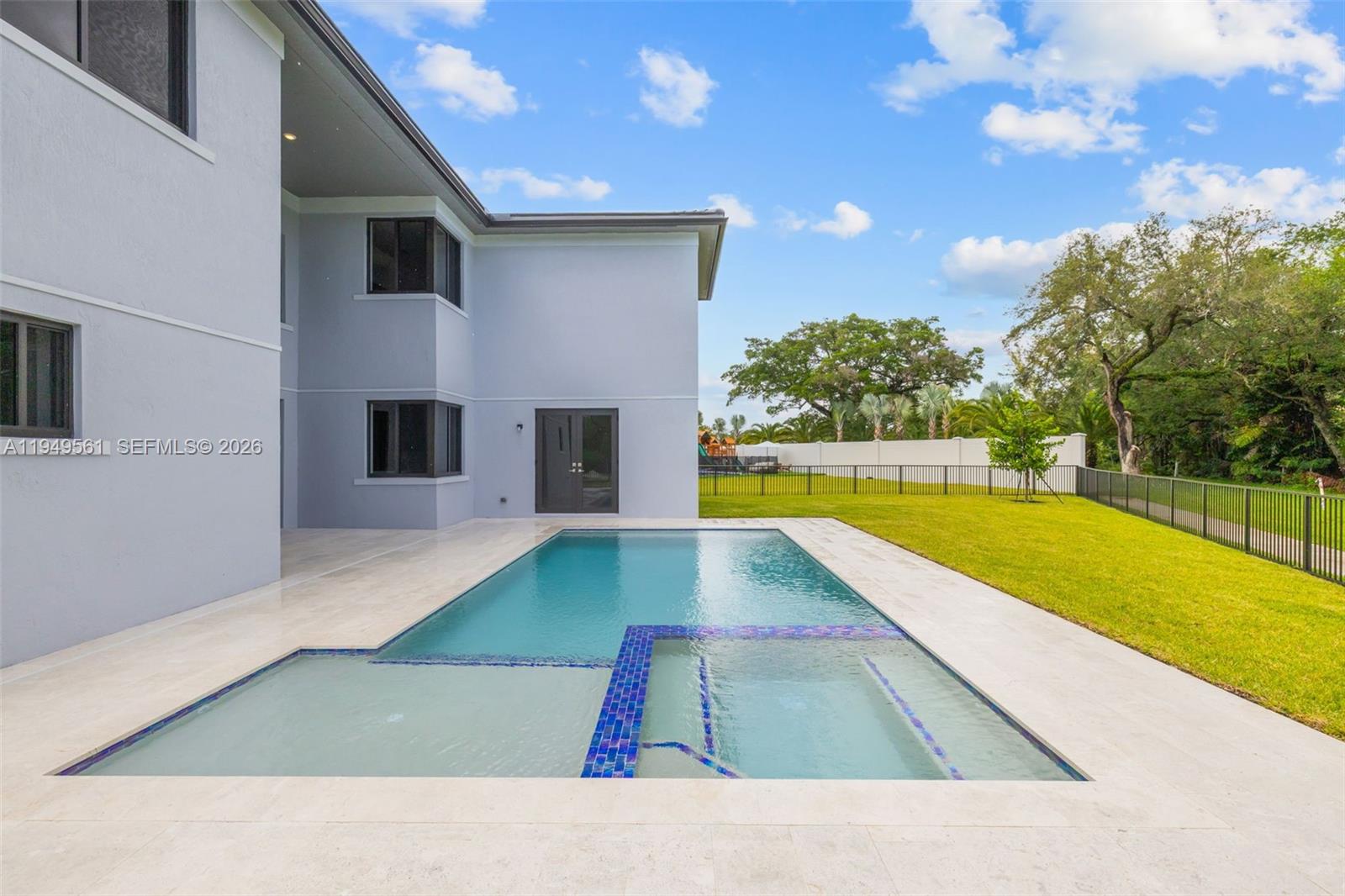 The exterior of a two-story house features a swimming pool with an attached spa — 19749 NE 16th Pl # 19749, Miami FL 33179, MIAMI, FL