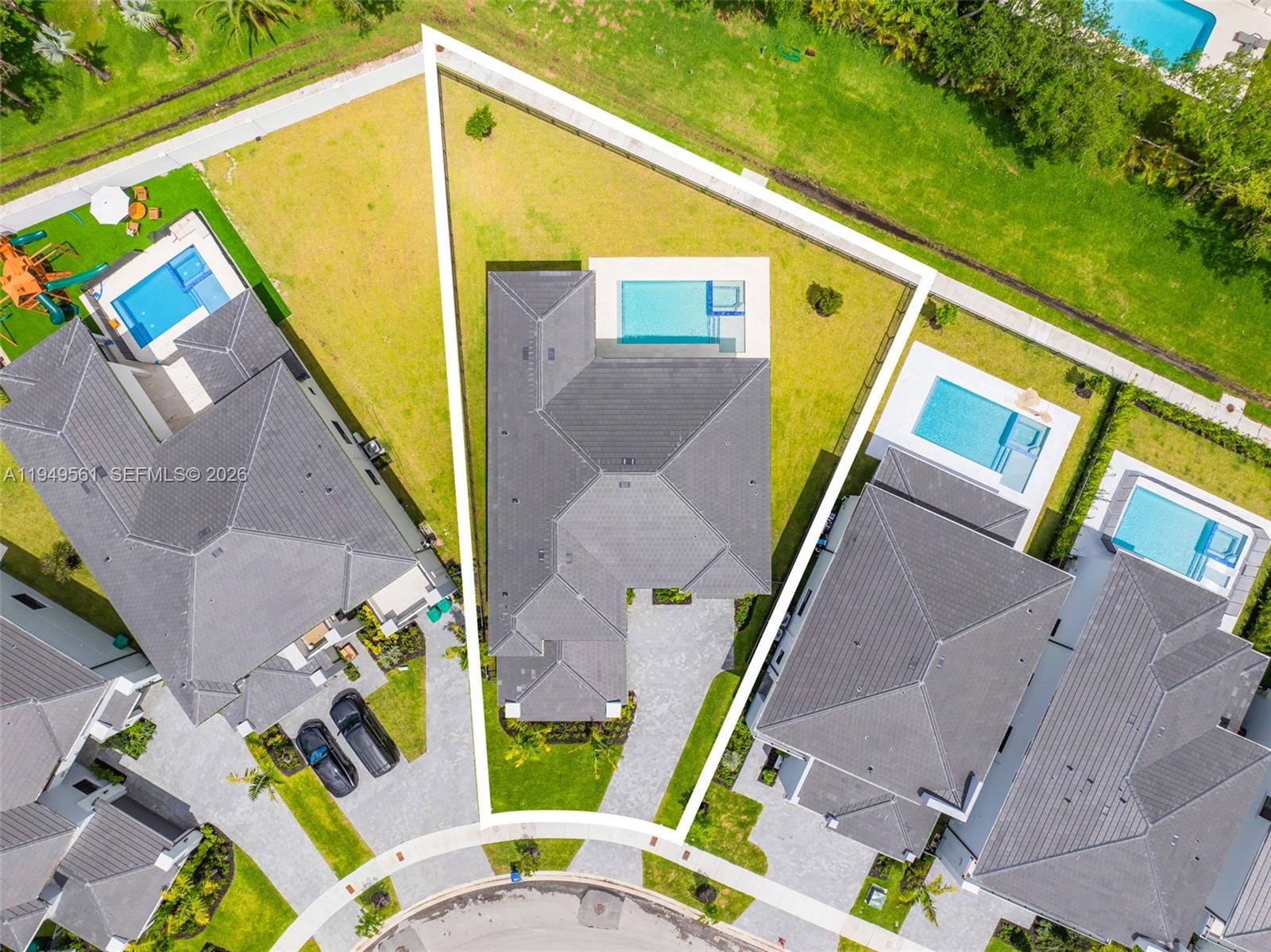 A two-story house with a swimming pool and spa sits on a grassy backyard lot — 19749 NE 16th Pl # 19749, Miami FL 33179, MIAMI, FL