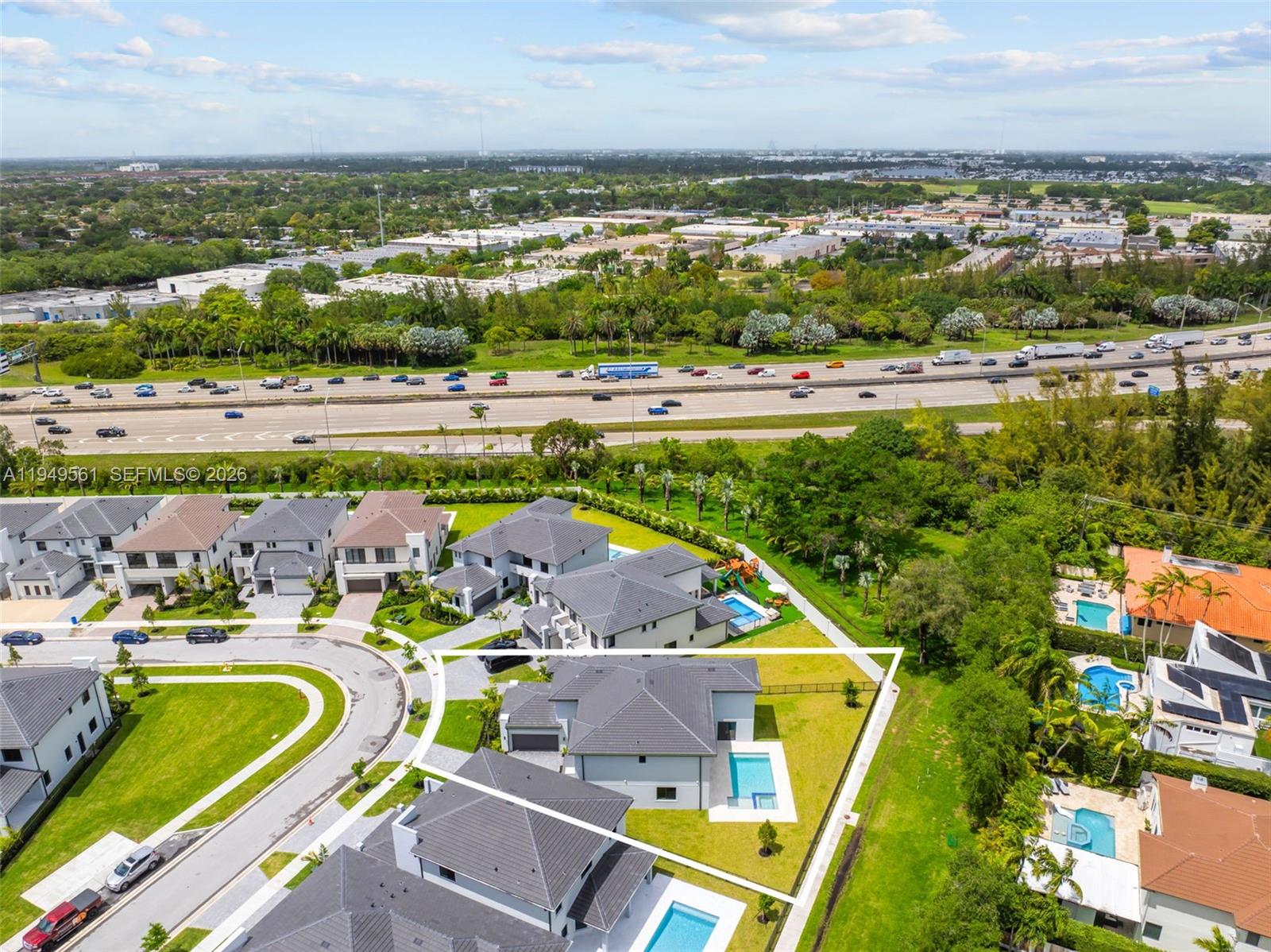 An aerial view shows a house with a pool and a large triangular backyard — 19749 NE 16th Pl # 19749, Miami FL 33179, MIAMI, FL