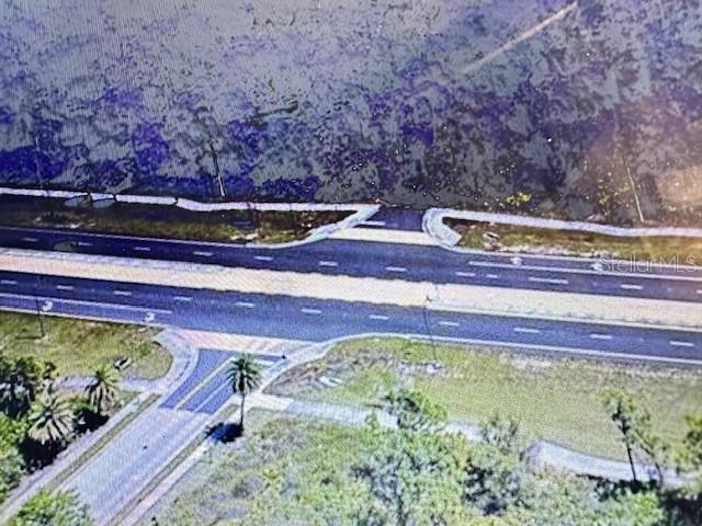 This aerial view shows a paved road intersection surrounded by grassy areas and trees — 0 S TOLEDO BLADE BOULEVARD N, NORTH PORT, FL