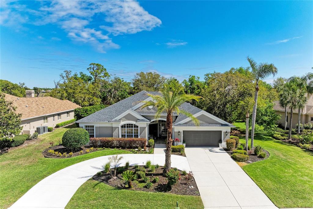 An aerial view of a single-story suburban house with a gray roof and driveway — 2337 LITTLE COUNTRY ROAD, PARRISH, FL