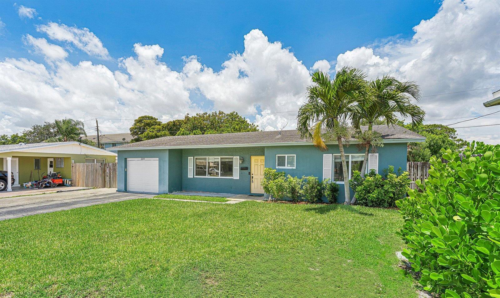 A single-story teal house with a garage, a front lawn, and a palm tree — 301 SE 3rd Street, Deerfield Beach FL 33441, DEERFIELD BEACH, FL