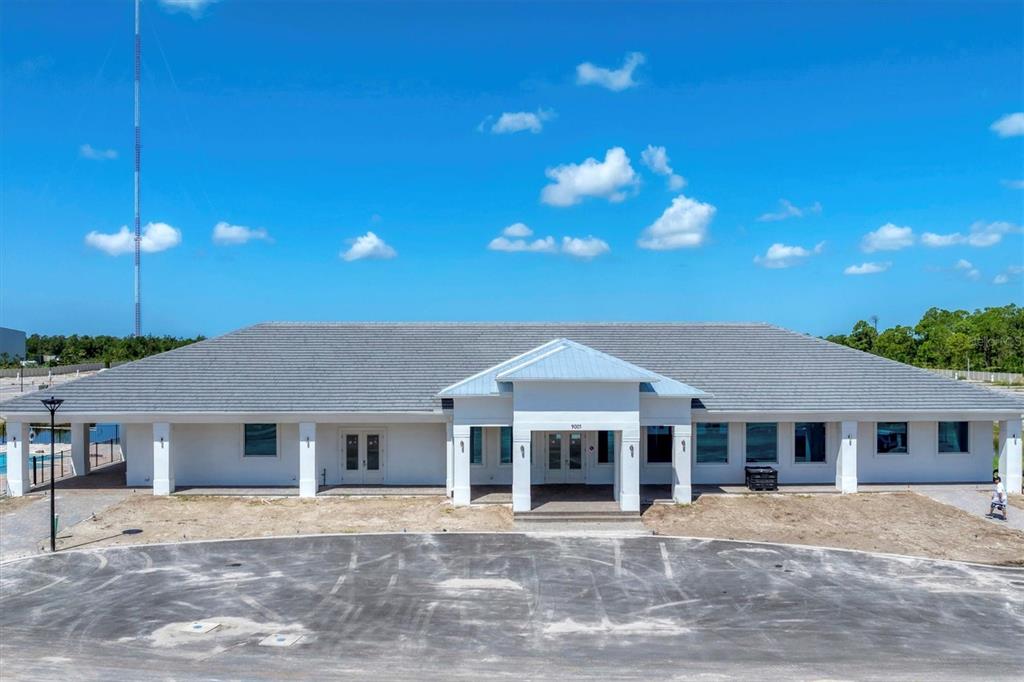 A single-story white commercial building with a gray tiled roof and a paved parking lot — 9001 GASPARILLA ROAD UNIT 35, PLACIDA, FL