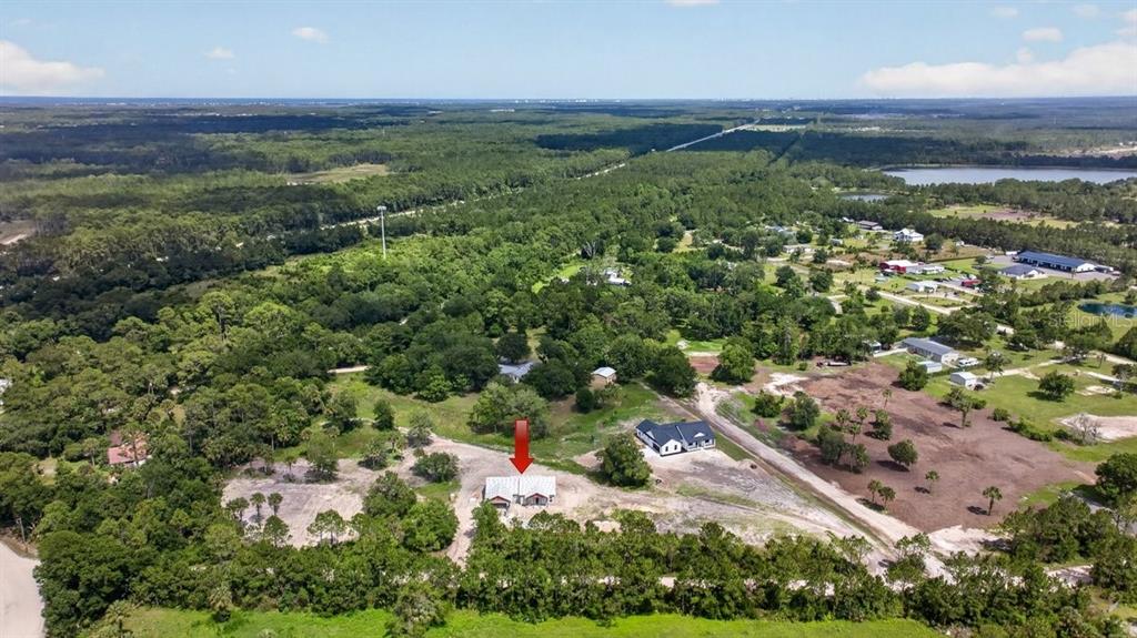 An aerial view shows a house under construction on a large, partially cleared rural lot — 31 FAVORETTA ROAD, BUNNELL, FL