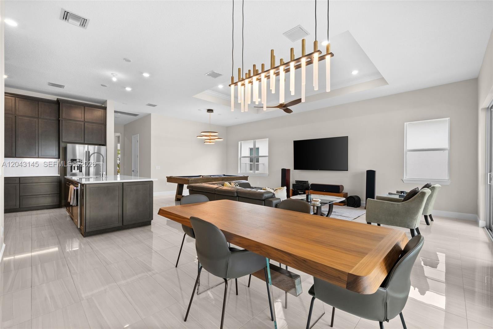 An open-concept living area features a kitchen, dining table, pool table, and television — 257 Zelda Ln, Delray Beach FL 33445, DELRAY BEACH, FL