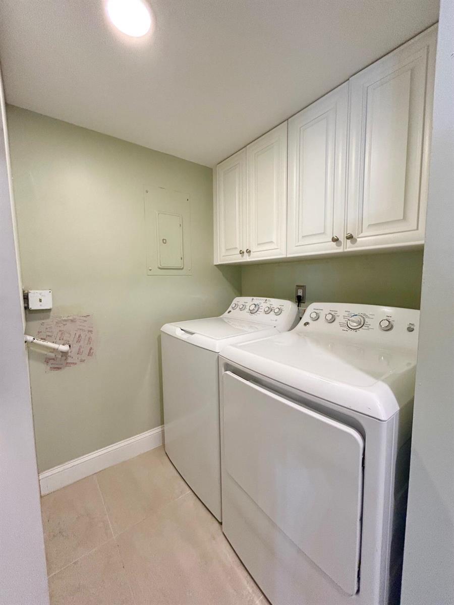 A bedroom features a dark wood bed frame, matching nightstands, a desk, and a ceiling fan — 140 Lake Pine Circle # 1, FL 33463, FL
